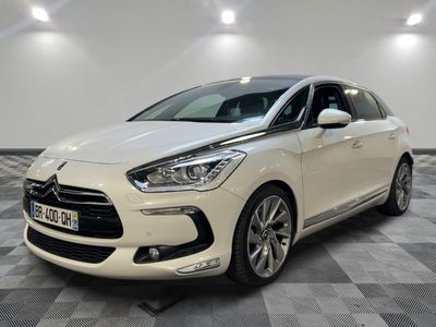 a white car parked in a room with a checkered floor