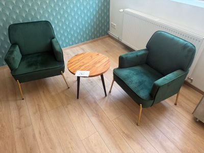 two chairs and a table in the corner of a room