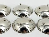four silver metal bells on a white background