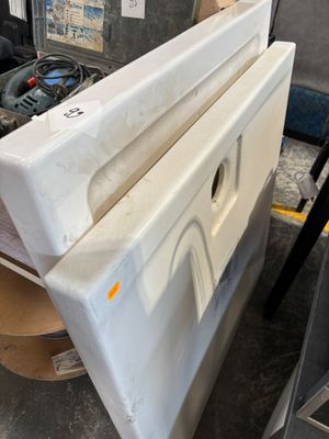 an image of a white refrigerator in a garage