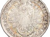 a silver coin with the image of the virgin of guadalupe on it