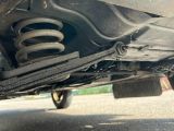 a close up of a car ' s rear end with a shock absorbr