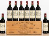six bottles of wine in a wooden crate on a table