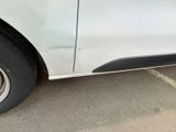 a white van parked in a parking lot with its door open