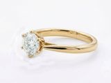 a gold engagement ring with a round brilliant cut diamond