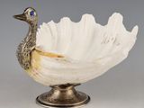 a white bowl with a duck on top of it