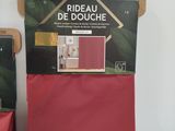 two boxes of red curtains on a shelf next to each other