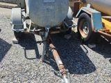a trailer with a tank attached to it on the side of the road