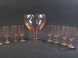 an image of a group of wine glasses sitting on top of a table