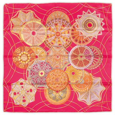 a pink scarf with a bunch of different designs on it