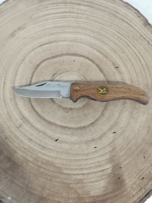 a knife that is sitting on top of a piece of wood