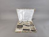 a case with silverware inside of it on a table