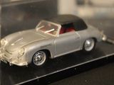 a toy car in a clear display case on a table