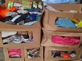 several boxes of clothing are stacked on top of each other in a room