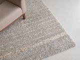 an image of a living room with a couch and a rug