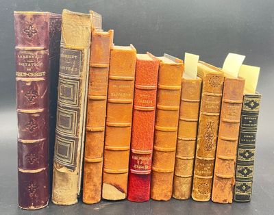 several old books are lined up in a row on a table