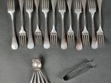 a lot of forks and spoons that are on the table