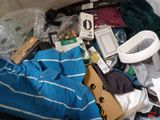 a suitcase full of clothes and other items on the floor