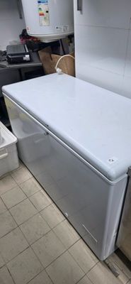 a white refrigerator sitting in a kitchen next to a sink