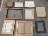a lot of framed pictures on the floor in the room