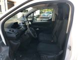 the interior of a small white car with the door open