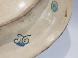 a white bowl with a blue flower design on it