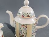a tea pot and a cup on a table