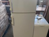 a white refrigerator and freezer sitting in a room