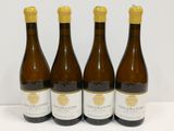 three bottles of wine sitting on top of a white table