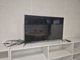 a flat screen tv sitting on top of a white entertainment center