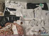 a lot of clothes that are sitting on a table
