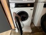 a washer and dryer in the corner of a room