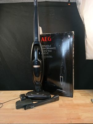 un aspirateur posé sur une table à côté d'une boîte
