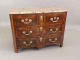 an antique chest of drawers with marble top and brass handles