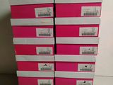 a stack of pink boxes sitting on top of a white table