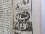an open book with a drawing of a man sitting in a chair