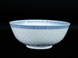 a blue and white bowl sitting on a black surface