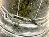 a close up of a metal vase with a marble base