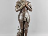 an image of a statue of a woman holding a dog