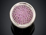 a close up of a pink diamond ring on a black surface