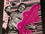 a close up of a poster on a table with a person holding a pink object