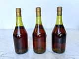 three bottles of wine that are sitting on a table