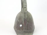 a metal bell with a hole in the middle of it