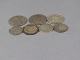 a pile of coins sitting on a table next to each other