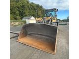 the back end of a bulldozer sits in a parking lot