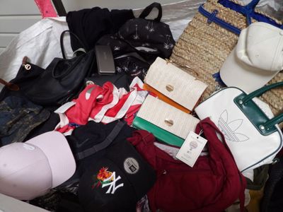 a pile of purses and handbags sitting on a table