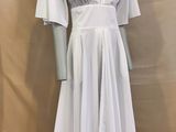 the mannequin is wearing a white dress on a mannequin stand