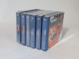 four cassettes stacked on top of each other on a white surface