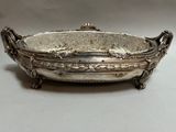 silver plated bowl with handles and handles on a white surface