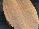 a close up of a wooden cutting board on a black surface
